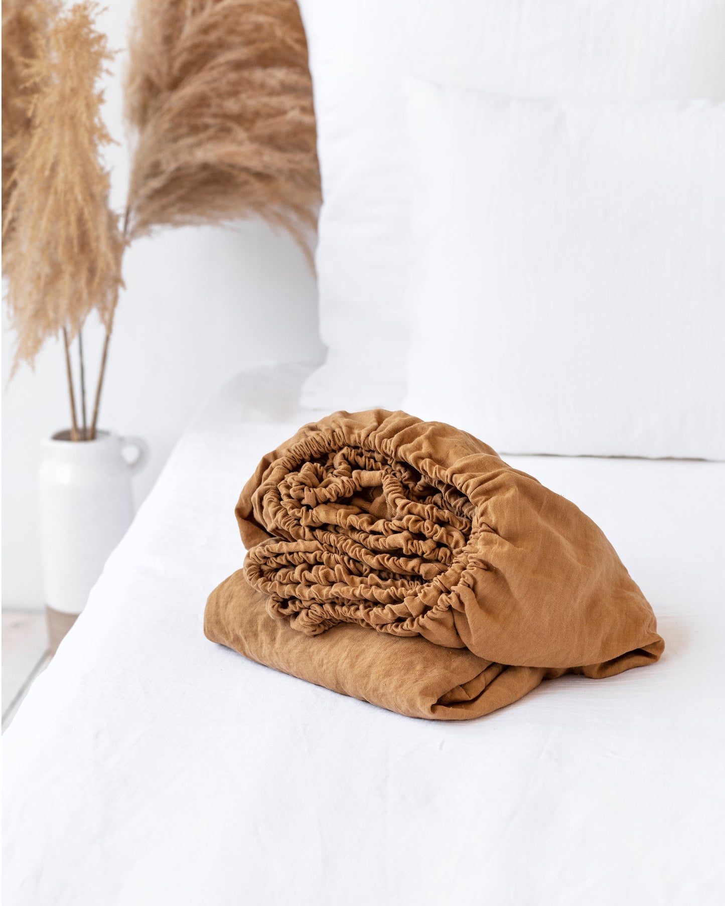 https://cdn.shopify.com/s/files/1/0640/8454/1699/products/tan-linen-fitted-sheet-1.jpg?v=1660218568